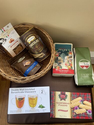 %%Coffee Lovers Basket%%, Donated by Stacy and John Perry; Included in a beautiful basket: Flavors of Italy Italian Roast Ground Coffee, Flavors of Italy Tuscan Tiramisu Coffee, Set of 2 Double Wall Insulated Borosilicate Glassware Mugs, Highland Specialty Shortbread Fingers, Classic Dolcetto Chocolate Cream Rolled Wafers, Zander Fine Chocolates Milk Chocolate Covered Almonds, and Nonna Ada Salted Caramel Biscotti; Wrapped in cellophane with a fancy bow, making it ready-to-give to the coffee lover in your life.