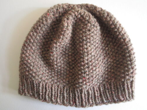 %%Hand Knitted Hat (6)%%, Made and donated by Ellen Orkins; Adult; 100% Wool; Light Brown; Knitted in the Seed Stitch.