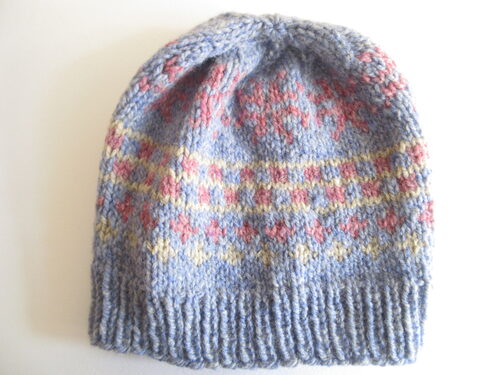 %%Hand Knitted Hat (7)%%, Made and donated by Ellen Orkins; Adult; 100% Wool; Blue, Pink, and Beige.