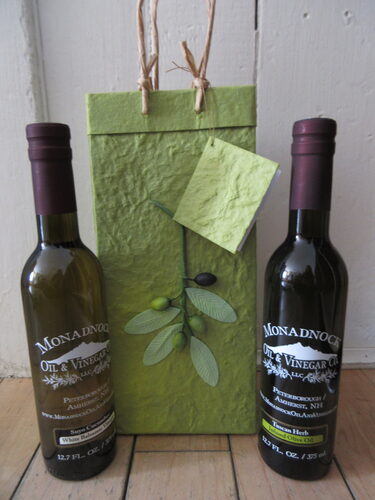 %%Monadnock Oil & Vinegar Co. and NH Herb & Spice Co.%%, Dublin, NH; Oil and Vinegar Set; Included in a decorative bag: Suyo Cucumber White Balsamic Vinegar 12.7 fl. oz. and Tuscan Herb Infused Olive Oil 12.7 fl.oz.; Come explore the healthy world of Extra Virgin Olive Oils, Infused & Fused Olive Oils, Balsamic Vinegars, Salts, Spices and our own Herb Blends. Try some of the many combinations from over seventy flavors of oils and vinegars. Also sell a variety of locally made and gourmet products. https://www.monadnockoilandvinegar.com/