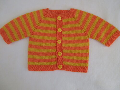 %%Handknit Infant Sweater%%, Made and donated by Anne Morris; Approximate size 6-9 months; Washable DK weight yarn; 75% acrylic and 25% wool; Yellow and orange with yellow buttons.
