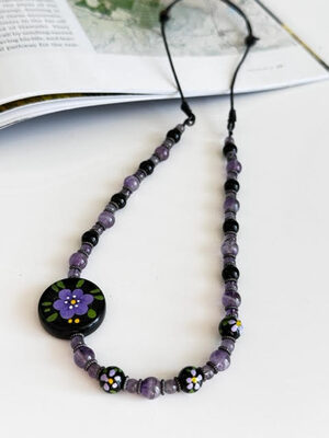 %%Handmade Necklace%%, Made and donated by Afton Rodriguez; Hand painted Lucite beads with amethyst, black onyx, pewter gun metal spacers and adjusters/stoppers; USA Leather Cording.