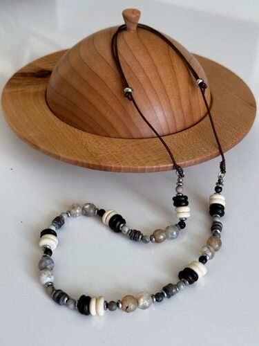 %%Handmade Necklace%%, Made and donated by Afton Rodriguez; African handmade brown and cream bone beads with mixed agate, grey seashell, hematite, and 925 sterling silver; USA Leather Cording.