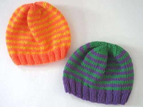 %%Two Handknit Infant Hats%%, Made and donated by Anne Morris, Peterborough, NH; Acrylic yarn; One hat is purple and green and the other hat is orange and gold.