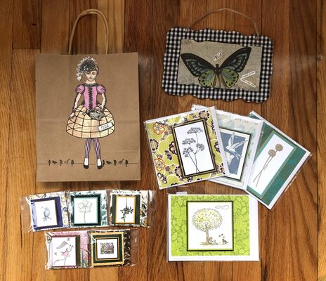 %%Handmade Stationery Gift Bag Set%%, Donated by Paperwhite Studio, Swanzey, NH; A beautiful selection of handmade greeting cards in a variety of whimsical, nature inspired prints and colors; Includes 4 large cards (approximate sizes 5"x5" to 5"x7") and 5 small cards (sizes 2.5"x2.5"); All cards include an envelope and are blank inside - perfect for any occasion; Gift set also includes a hanging sign with butterfly artwork and vintage bird inspired gift bag; all items are created locally by Paperwhite Studio. Studiopaperwhite@gmail.com